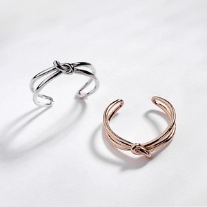Detailed view of silver and rose gold knotted open rings in high quality 18K gold plating
