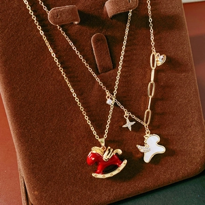 Detail of gold horse pendant with red enamel and white mother of pearl inlay