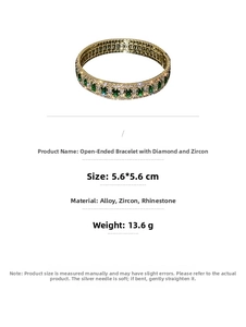 Detail of gold-plated alloy open bracelet with green zircon and white rhinestones
