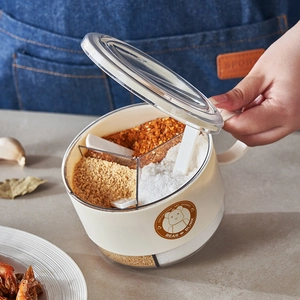 Three-grid seasoning box with spoons and airtight lids for organized kitchen storage