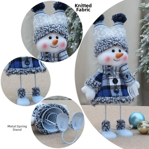 Detail of blue knitted fabric snowman with iron spring base for holiday decoration