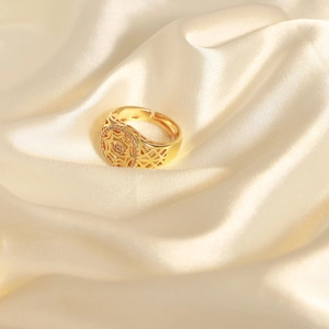 Minimalist gold geometric hollow ring with sparkling cubic zirconia on champagne silk