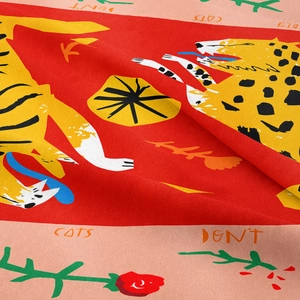 Detailed close-up of bohemian red tapestry showing printed leopard and floral fabric texture