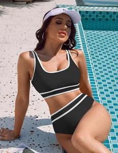 Detail of high-waisted black bikini bottoms with white contrast trim for a sporty look