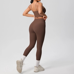 Detail showing high-waist yoga pants and back design of thin strap sports bra in brown