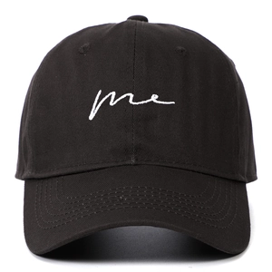 Black cotton baseball cap featuring white 'me' embroidery and a curved visor brim