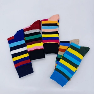 Flat lay of five pairs of colorful striped cotton athletic crew socks on white background