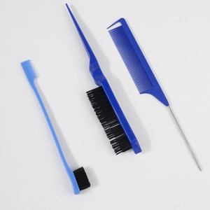 Macro shot of 3-piece hair styling set with steel needle tail comb and bristle brush