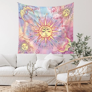 Dreamy sun and moon tapestry hanging above a white sofa in a bohemian styled room