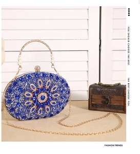 Macro detail of sunflower evening bag featuring blue crystals and gold chain strap