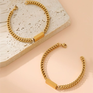 Detail of 18K gold plated Cuban and braided chains with blank rectangular ID plates