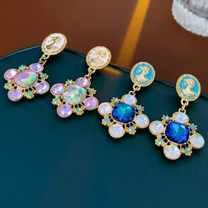 Detail of vintage flower earrings featuring oil-drop resin, relief portraits, and crystals