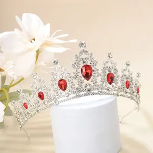 Detailed macro view of luxurious silver crown with ruby teardrop stones and white crystals