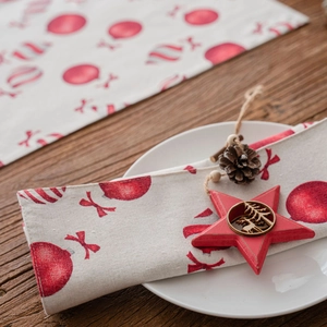 Christmas table runner with red festive ornaments and stars on rustic wooden background