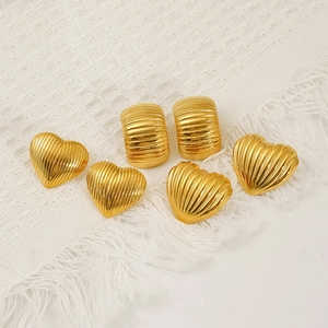 Golden heart and cylindrical stainless steel earrings with textured stripe pattern