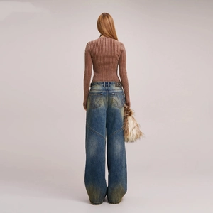 Detail view of brown ribbed knit cardigan paired with vintage distressed wide-leg jeans