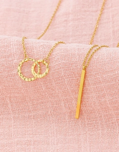 Detail view of 18K gold dainty choker with double rings and rectangle bar pendants