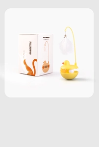 Detail of yellow duck tumbler cat toy with white feather and minimalist packaging box