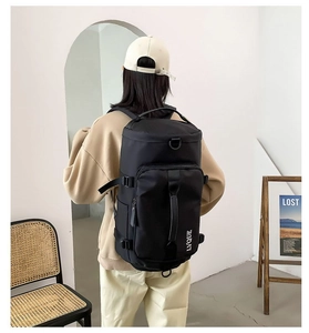 Detailed view of large black multi-functional travel backpack with reinforced handles