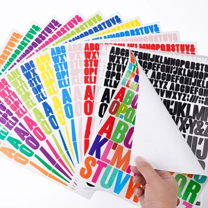 Detail of multi-colored vinyl alphabet stickers being peeled from a backing sheet