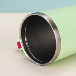 Close-up of the stainless steel rim and mint green interior of the 40oz insulated cup