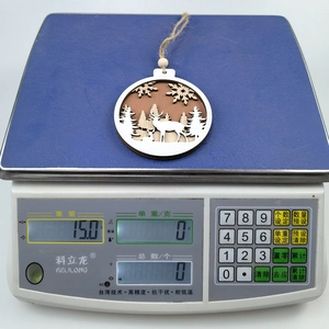 Detail showing carved wooden reindeer forest ornament on a scale weighing 15 grams