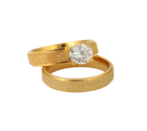 Detailed view of the sparkling zircon and frosted texture on these gold titanium rings