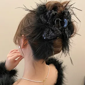 Elegant black hair claw clip with feather sequins and bowknot on Asian model