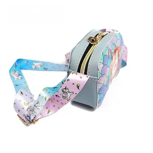 Detail of unicorn girl purse featuring colorful scales and a wide gradient strap
