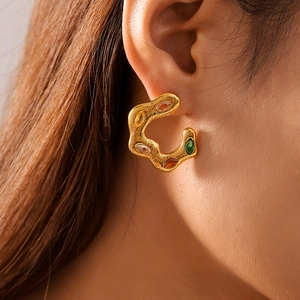 Irregular C-shaped 18k gold plated earrings with colorful zircon gemstones on model