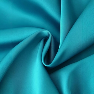 Elegant teal satin dress featuring a sophisticated pleated design and glossy silk texture