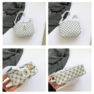 Detail view of cream PU leather crossbody bag with geometric pattern and gold deer charm