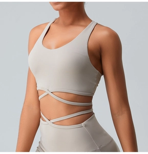 Close-up of nude yoga set featuring criss-cross back sports bra and high-waisted leggings