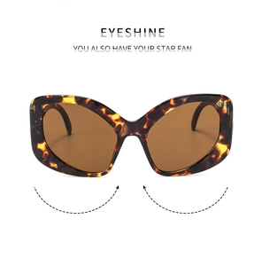 Macro shot of stylish tortoiseshell cat eye sunglasses with brown lenses on white