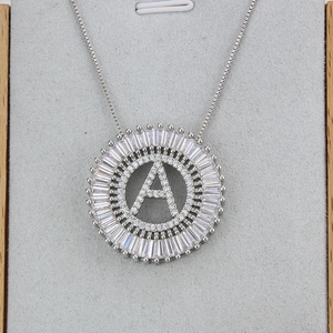 Macro shot of silver letter A pendant with baguette and round cubic zirconia stones