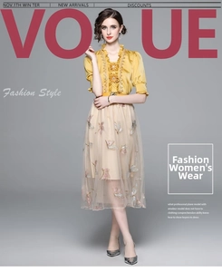 Detail of elegant two-piece dress featuring floral embroidery and yellow mesh tulle skirt