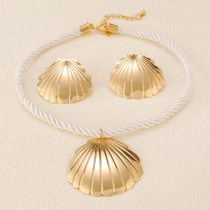 Minimalist gold seashell necklace and earrings set with white braided cord
