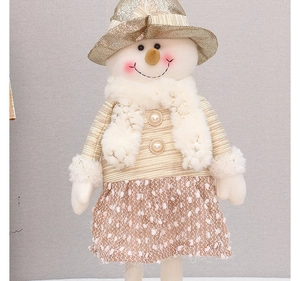 Detail of a Christmas snowman doll featuring gold sequins, pearl buttons and white plush fabric