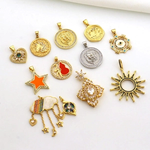 Macro shot of assorted sun and lion coin gold-plated pendants with cubic zirconia