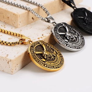 Retro eagle round pendant necklace set in gold, silver and black on stone background