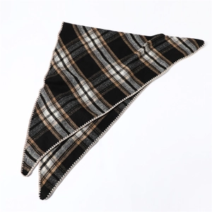Close-up of a warm plaid triangle scarf featuring classic black and brown checkered pattern