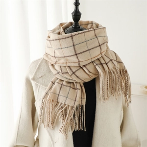 Close-up of beige plaid scarf featuring soft cashmere-like texture and tassel detail