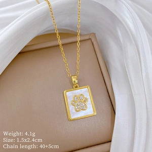 Macro detail of a gold cat paw square pendant with dimensions and weight specs