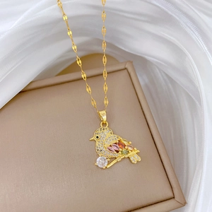 Luxury gold bird pendant necklace with sparkling micro-pave zircons in a jewelry box