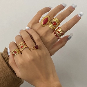 Detailed close-up of retro 18k gold plated stainless steel rings with red agate stones