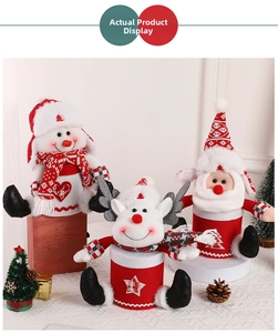 Detail of knitted Christmas treat boxes featuring snowman, reindeer, and Santa designs