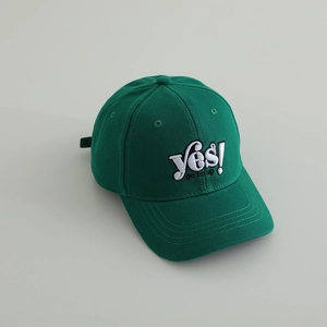 Deep green cotton baseball cap with 'Yes!' embroidery on a light gray background