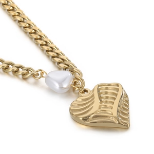 Double-layered gold chain necklace featuring freshwater pearl heart and textured metal heart