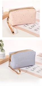 Detail of pink and blue cosmetic bags with gold star patterns and metallic zippers