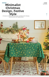 Detailed view of forest green Christmas tablecloth with gold snowflake and bell patterns